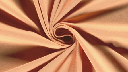 Perzik kleurige effen tricot stof van Nooteboom