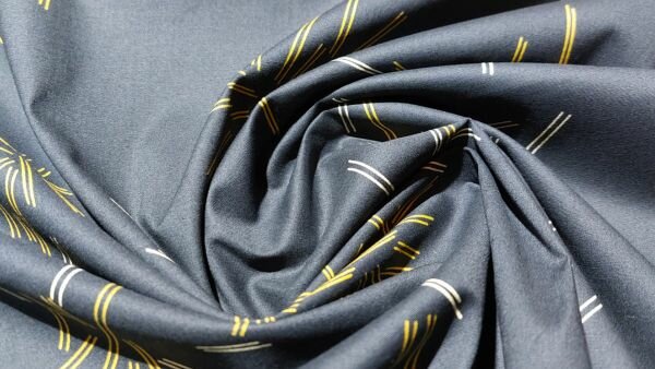 Detail van de gouden en beige streepjes op marineblauwe stretch katoen.