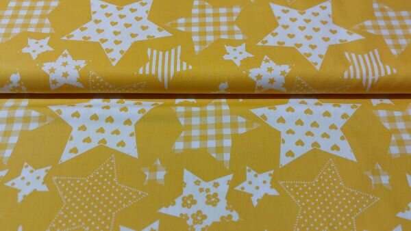 Gele katoenen stof met witte sterren close-up