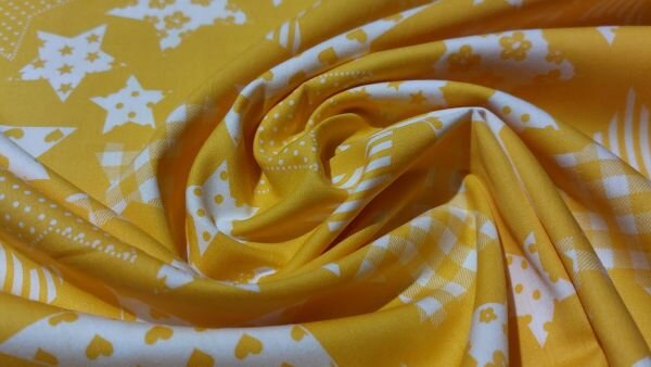 Detailfoto gele stof witte sterren patroon