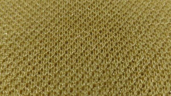 Okergele gebreide stof met stretch close-up