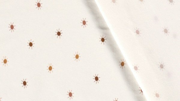 Brede 150 cm katoenjersey met subtiel zonnen dessin &mdash; detailfoto
