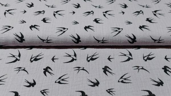 Licht paarse mousseline stof met zwaluwen motief