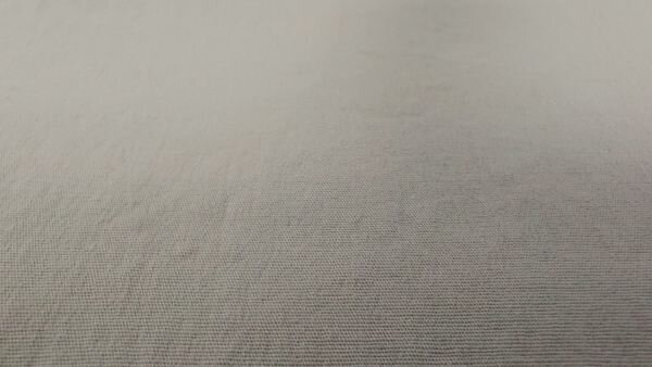 Close-up van soepele poplin stretch stof in beige/zand