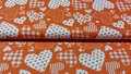 Oranje poplin katoen met witte hartjes &ndash; 100% katoenen stof